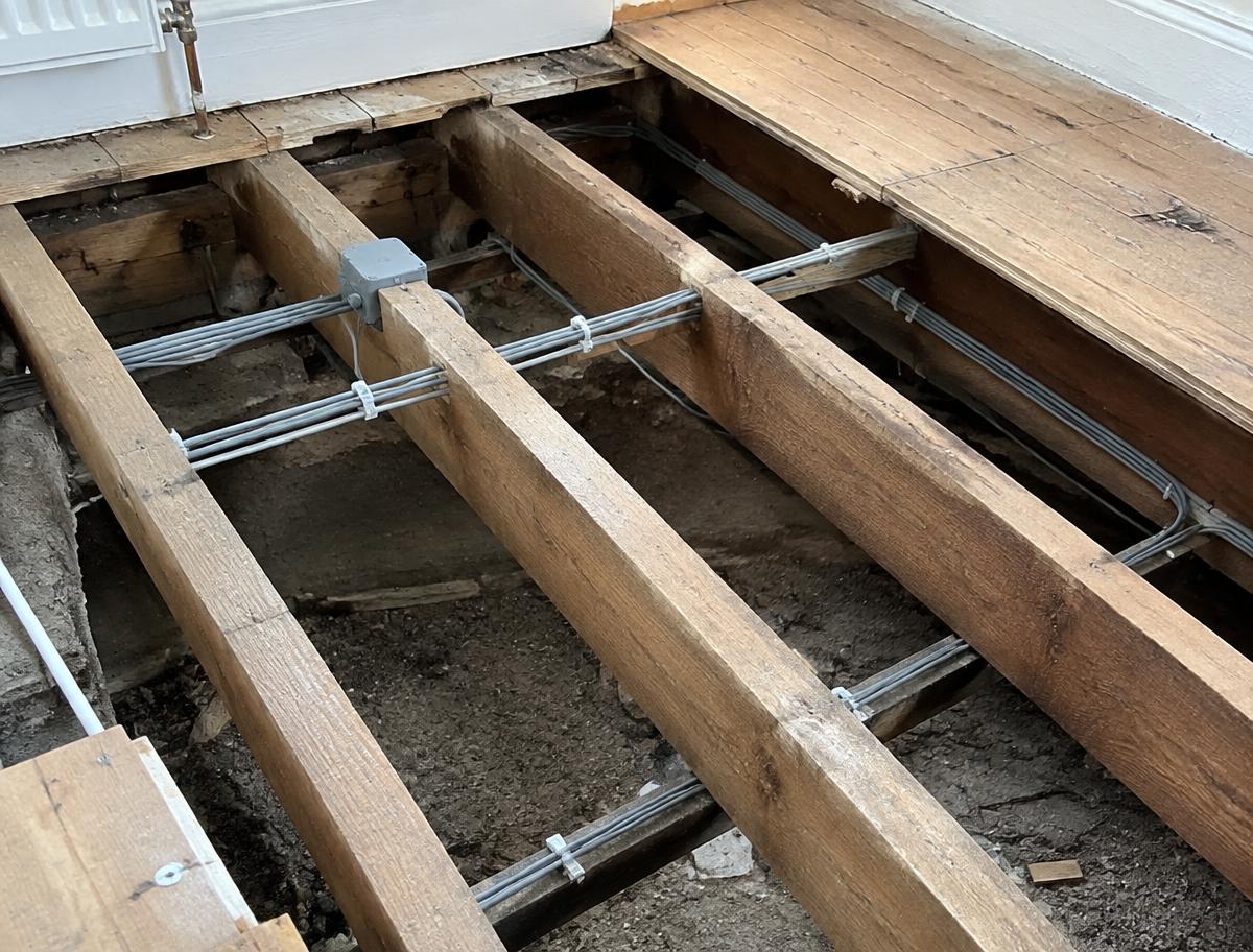 New cables clipped to floor joists during first fix